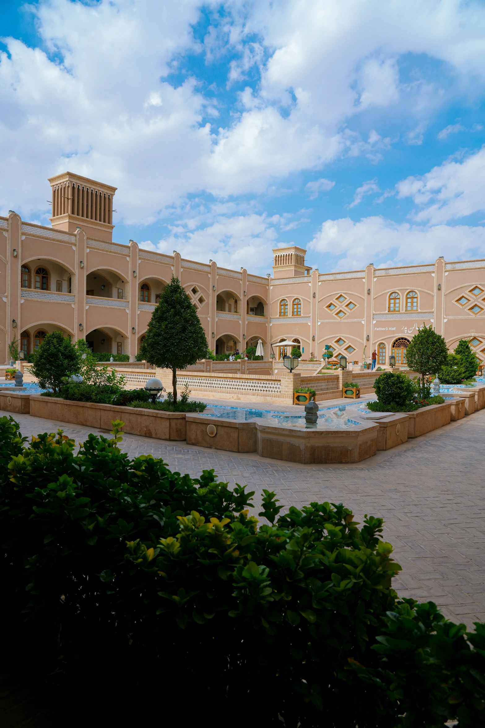 a beautiful building sits in front of a garden