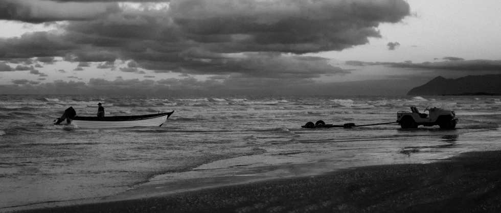 a couple of people on a boat near the ocean