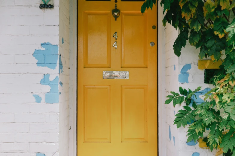 there is a bright yellow door that is on the front of the building