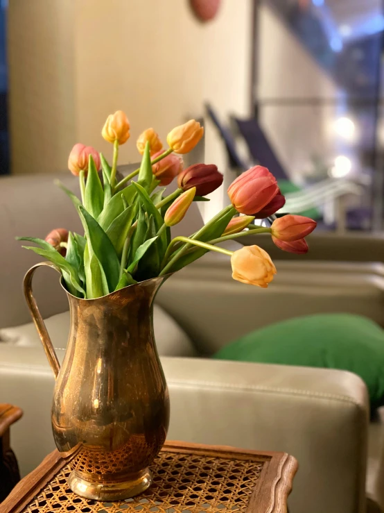 there is some flowers in a silver pitcher