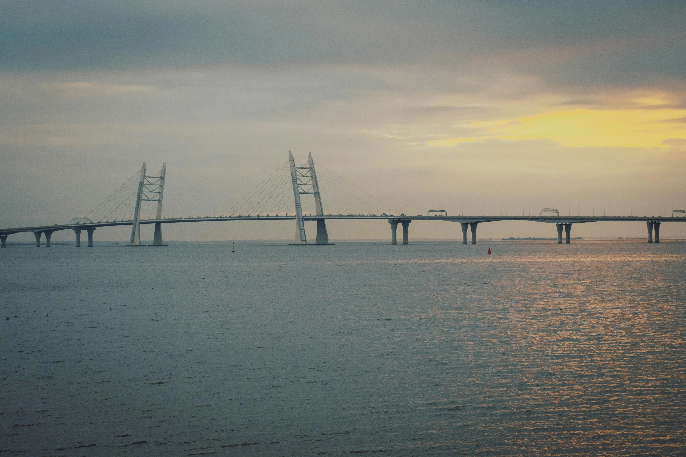 the long bridge is over water at the beach