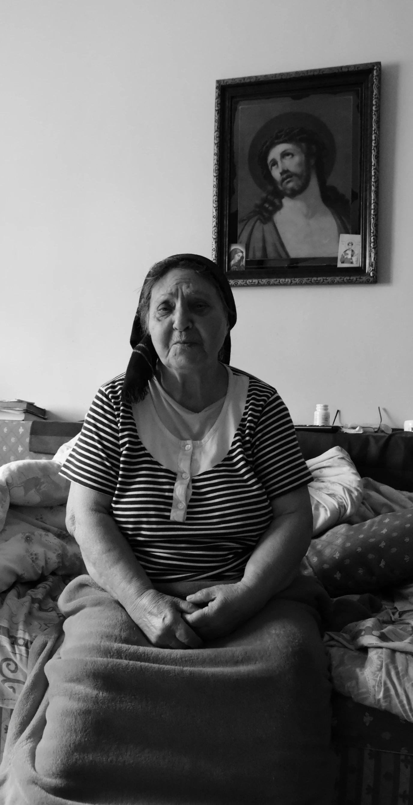 black and white pograph of woman sitting on couch