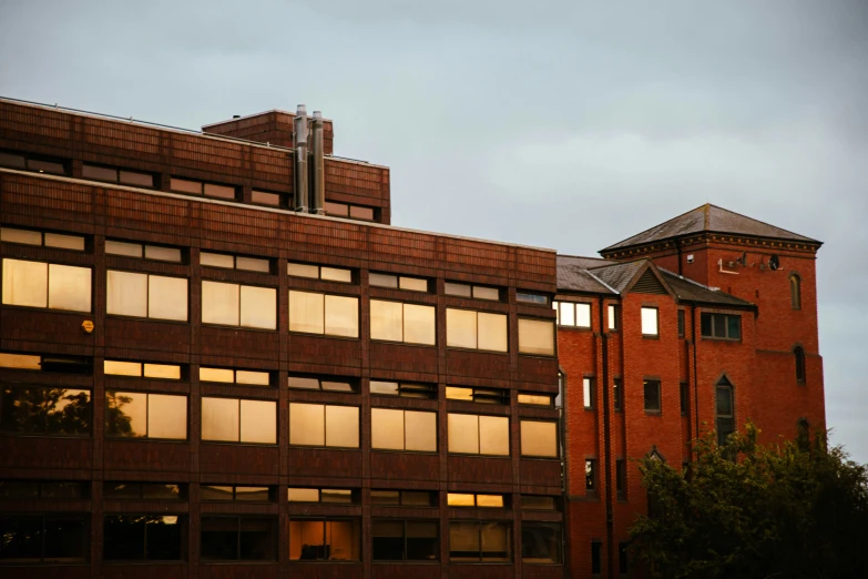 a red brick building that has windows and a clock tower