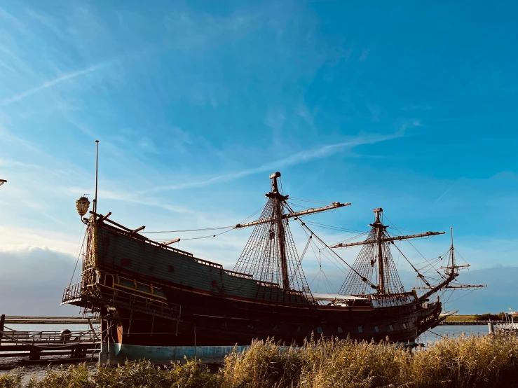 large boat sitting in a harbor during sunset