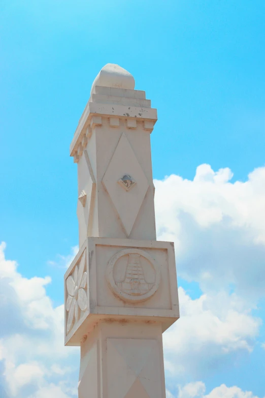 a tall, ornate pillar against a blue sky