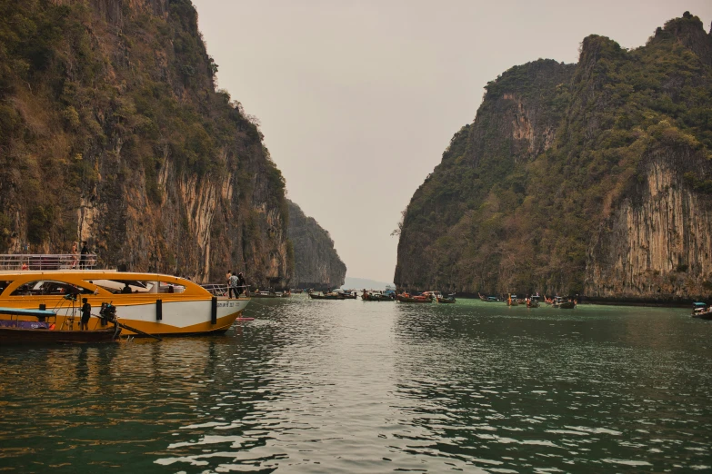 boats on the water near a large mountain range