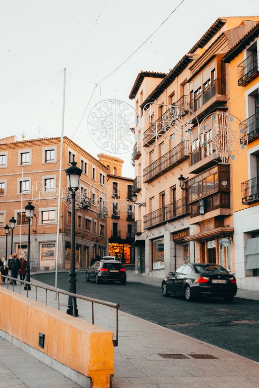 an older looking city street with cars parked on the street