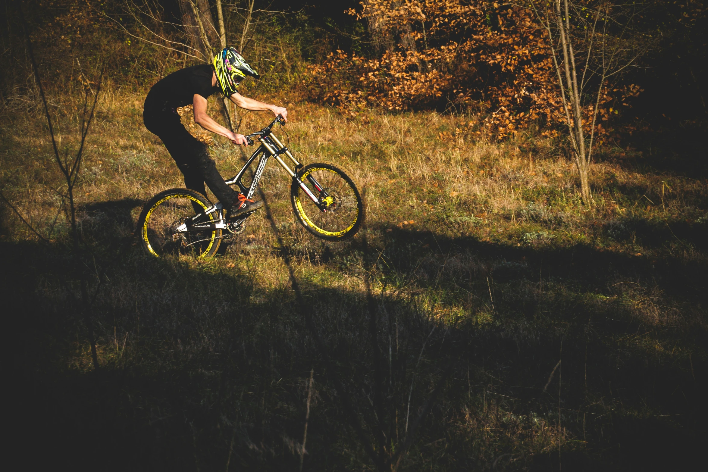 a man riding a bike through a grassy field