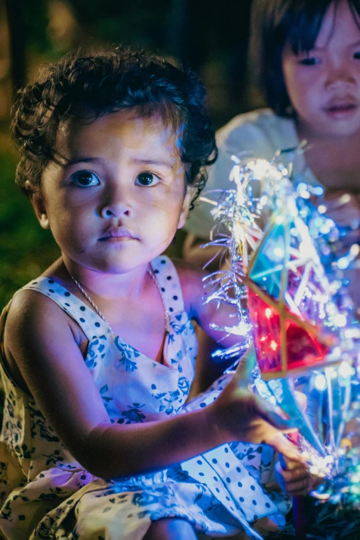 two little girls with fake fireworks on their chest