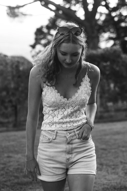 an attractive woman with long hair in shorts walking down the sidewalk