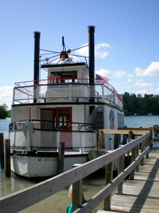 a large white and red boat sits in the water