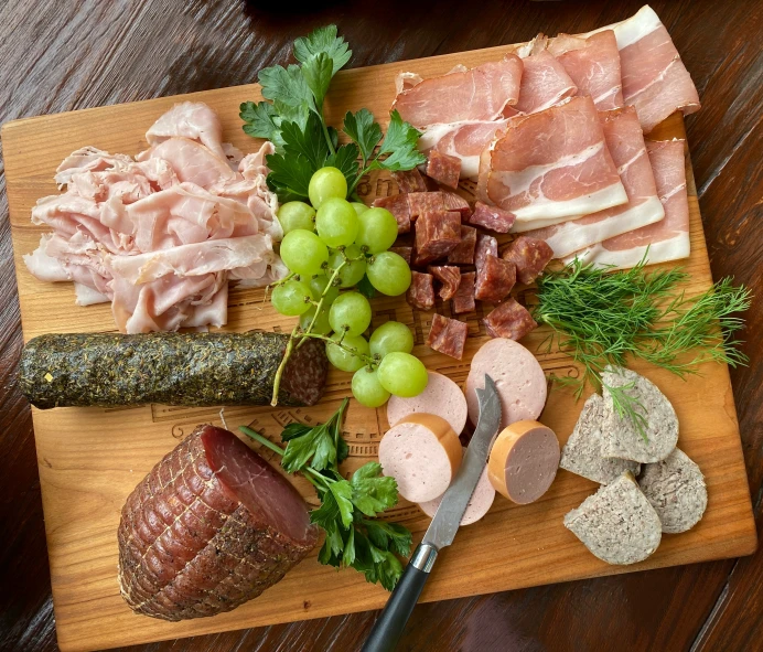 a  board with different types of food and a knife