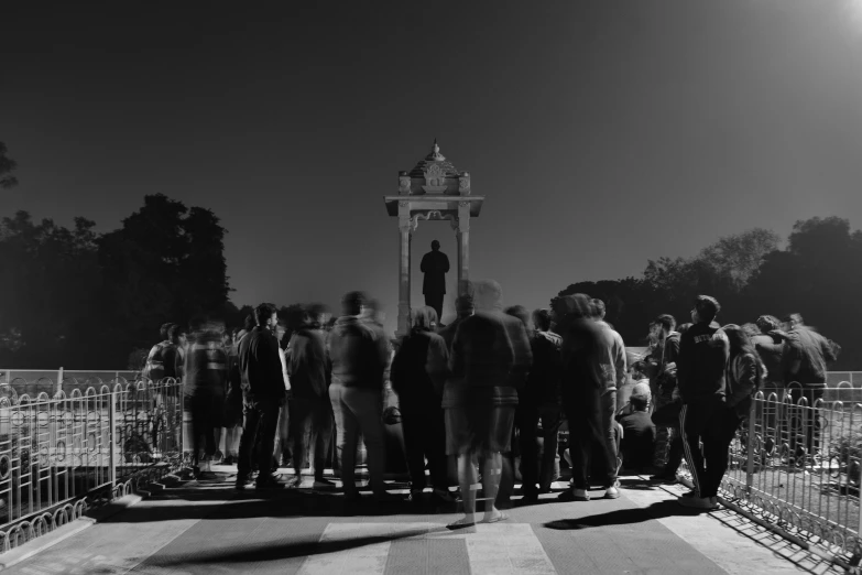 a bunch of people that are walking across a bridge