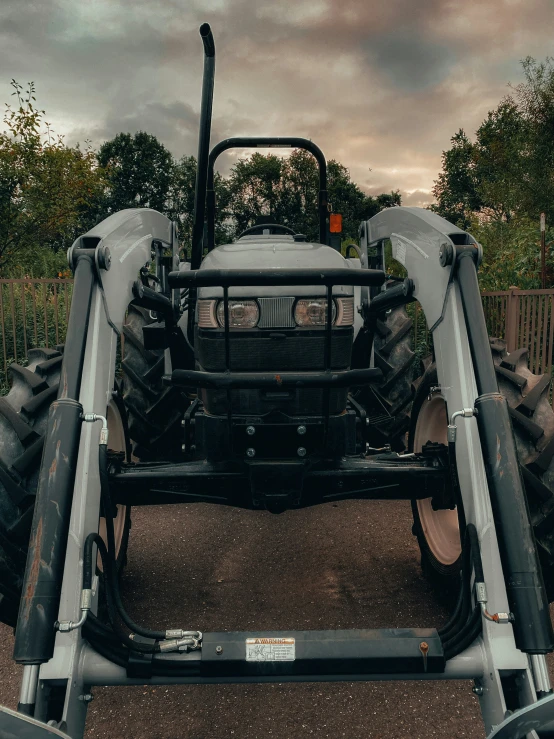 two people are behind the rear wheels of a tractor