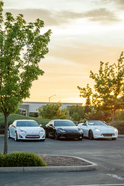 two white sports cars parked next to each other