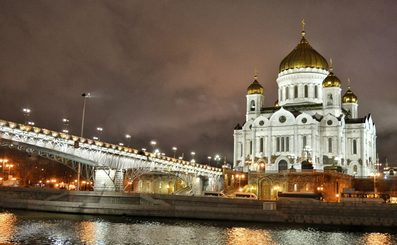 the cathedral has golden domes and lights on it