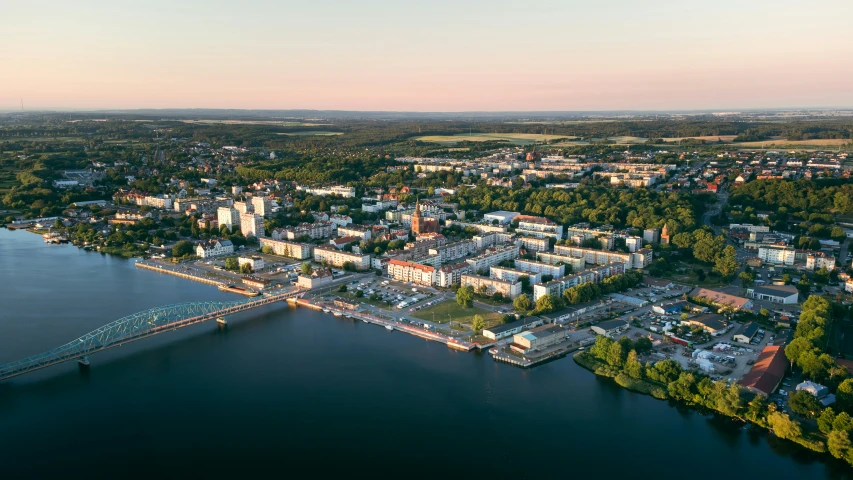 an aerial view of a waterfront town with a bridge and a harbor