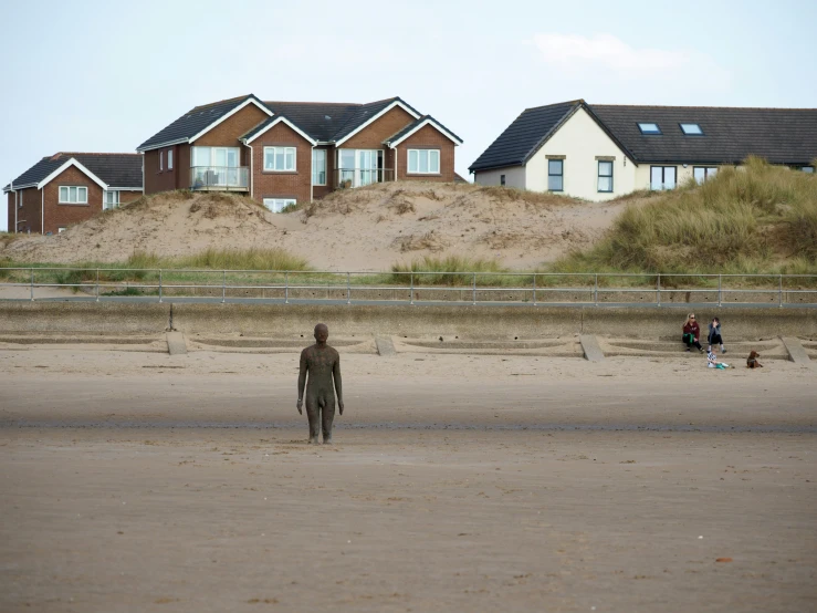 a man is standing alone in the sand