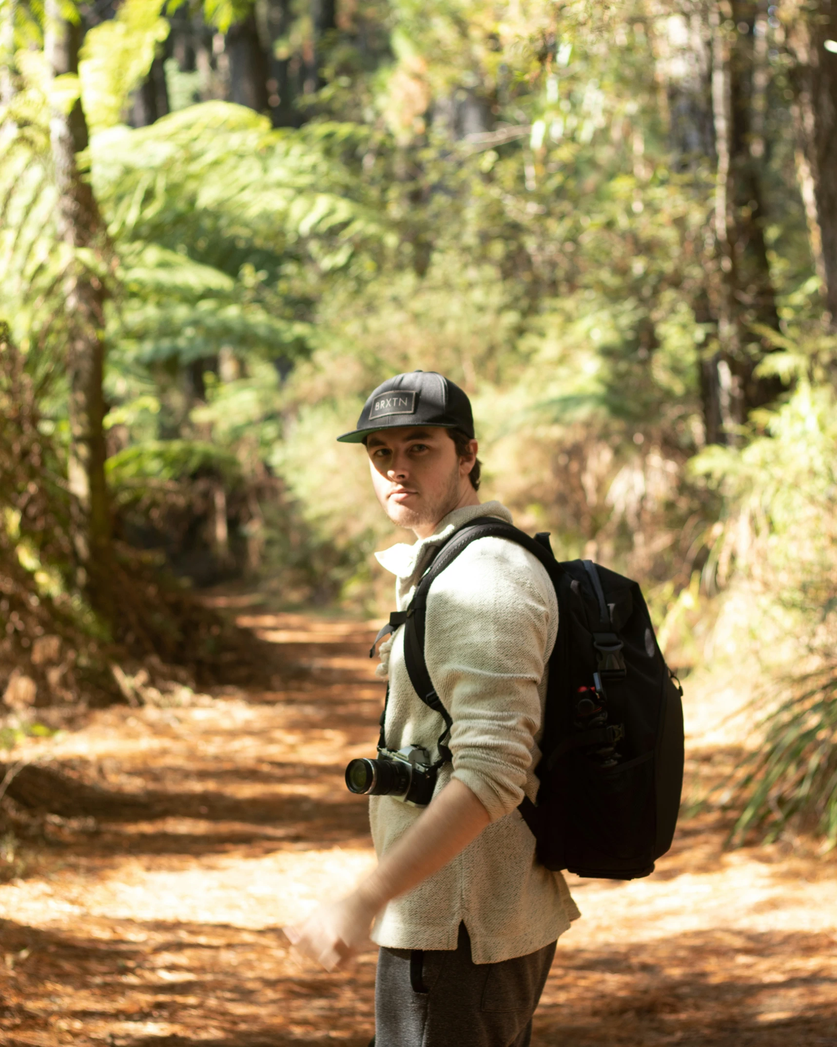 the man is walking on a trail in the woods