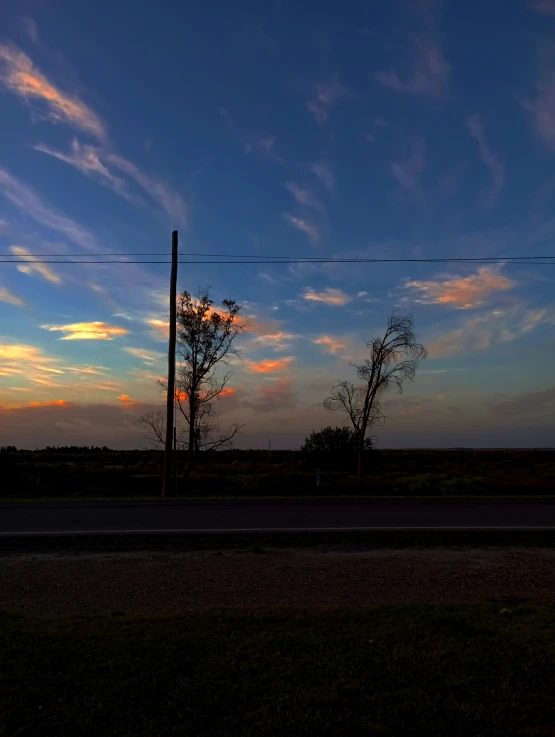 a sunset po of trees and sky