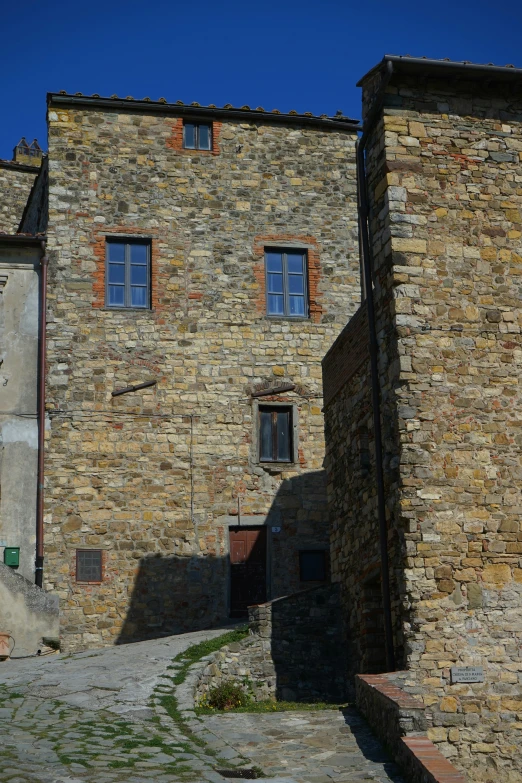 a street with many tall buildings and a clock on a wall