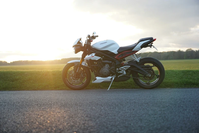 a white motorcycle parked on top of a parking lot