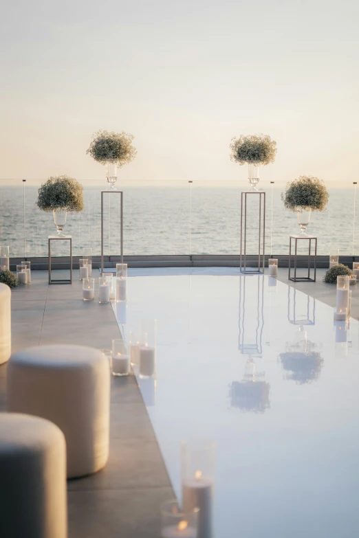 rows of candles lined up near the edge of an empty swimming pool