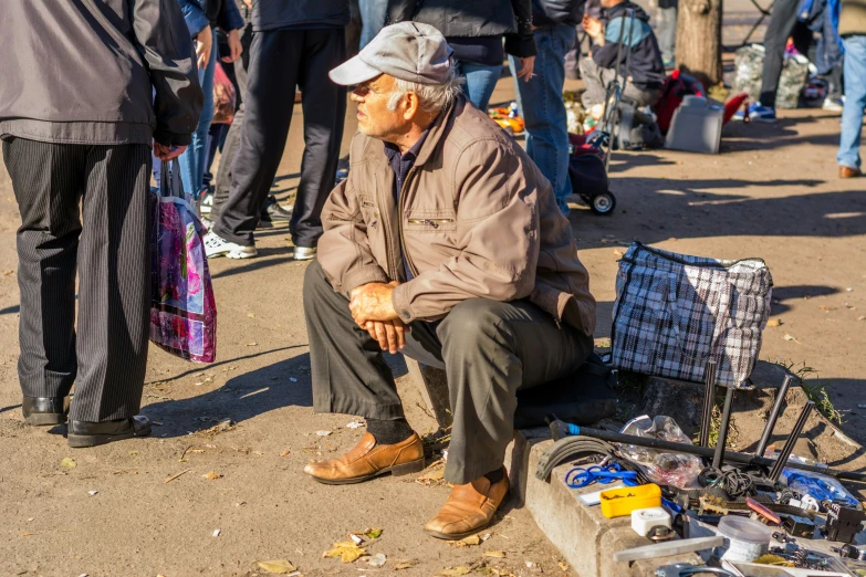 a man sitting on the ground with some electronics