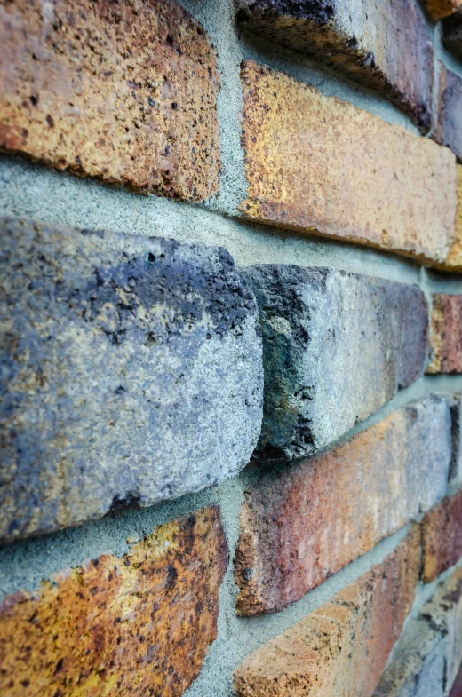 a brick wall with brown, blue and yellow mortar