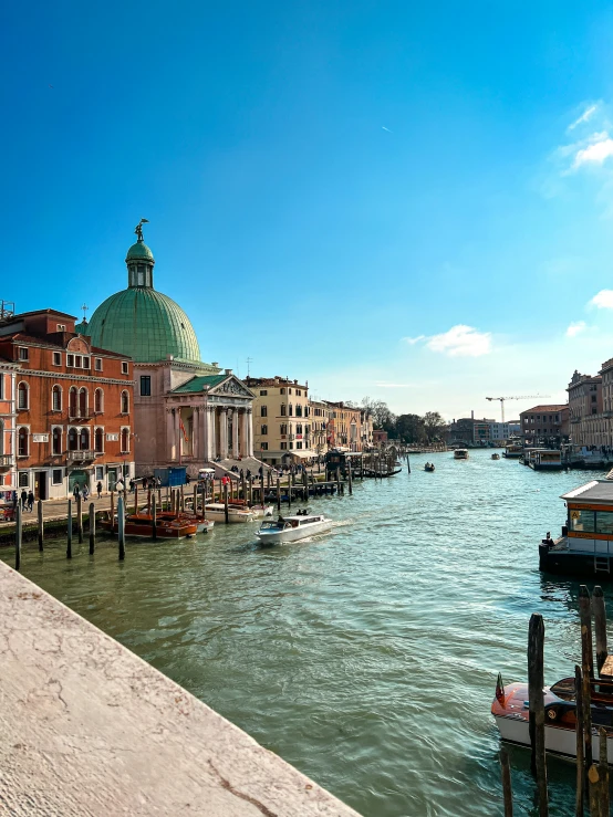 some buildings a river and boats a clock tower