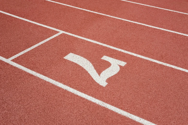 a red and white track running line on a running field