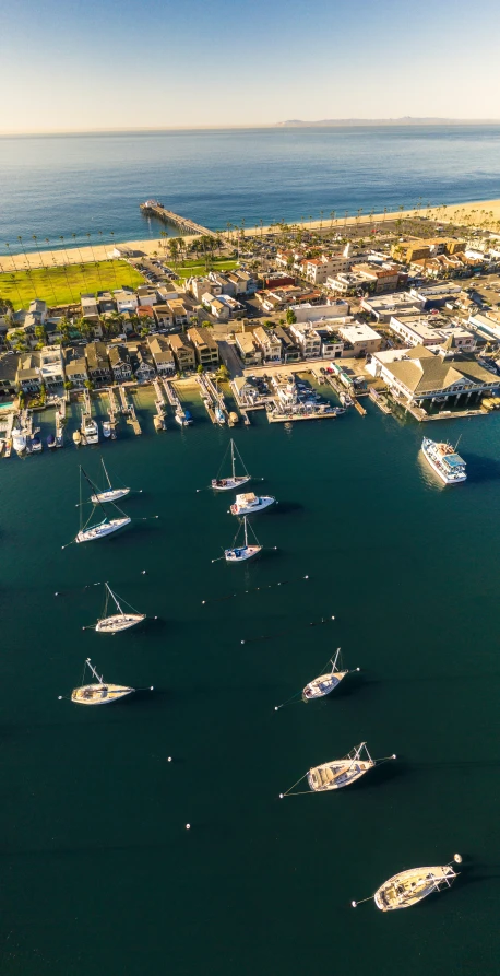 several boats anchored in the harbor of a small town