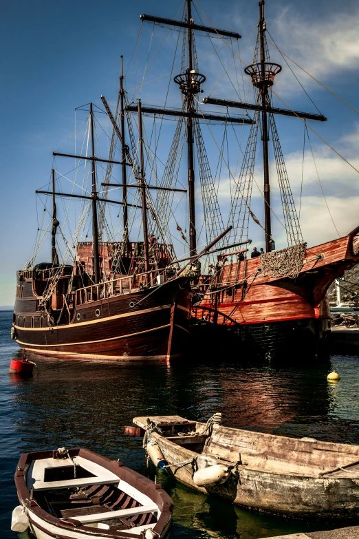 old fashioned ship sits anchored in the port of a city