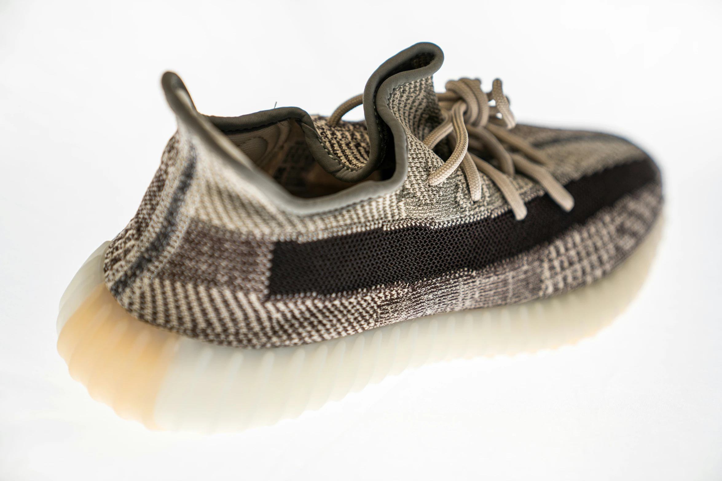 a close up of a gray and black shoe on a white background