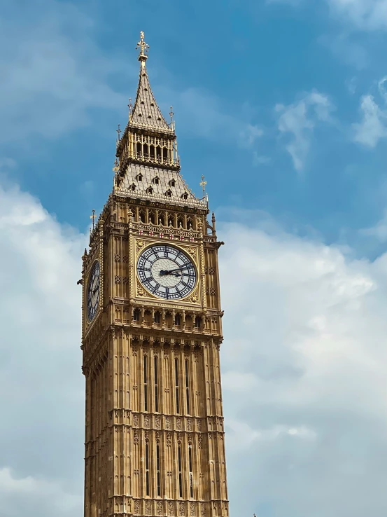 there is a clock on the tower and sky background