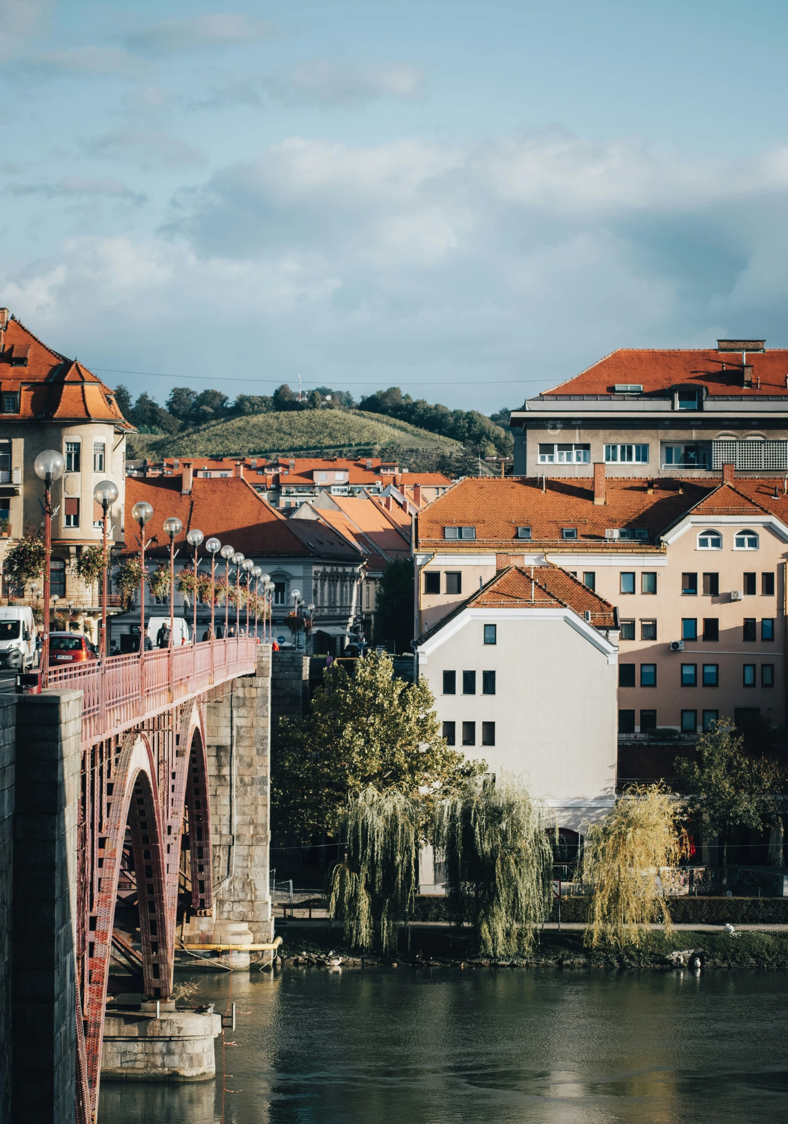 a bridge spanning across a river next to some tall buildings