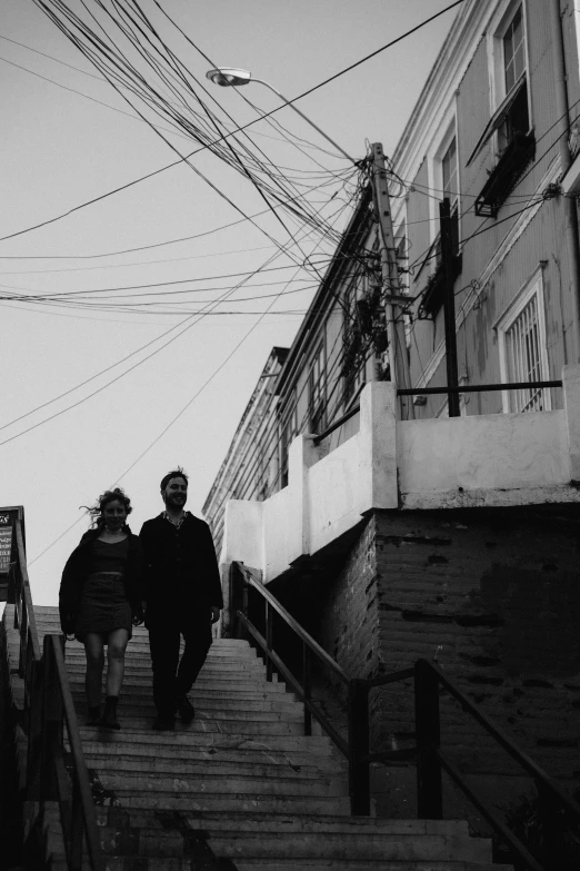 two people walking up some wooden steps