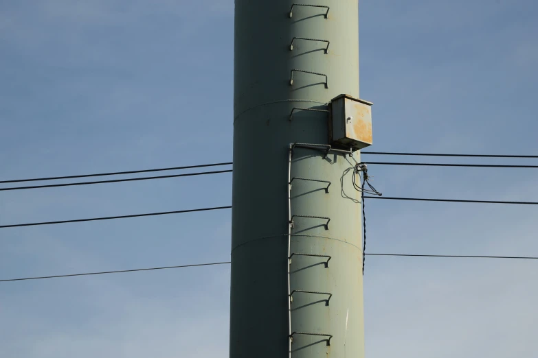 power lines and wires with a telephone pole that says one way