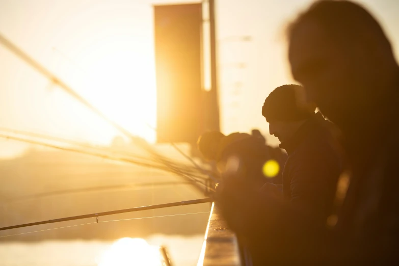 two men fishing on a sunny day on the deck