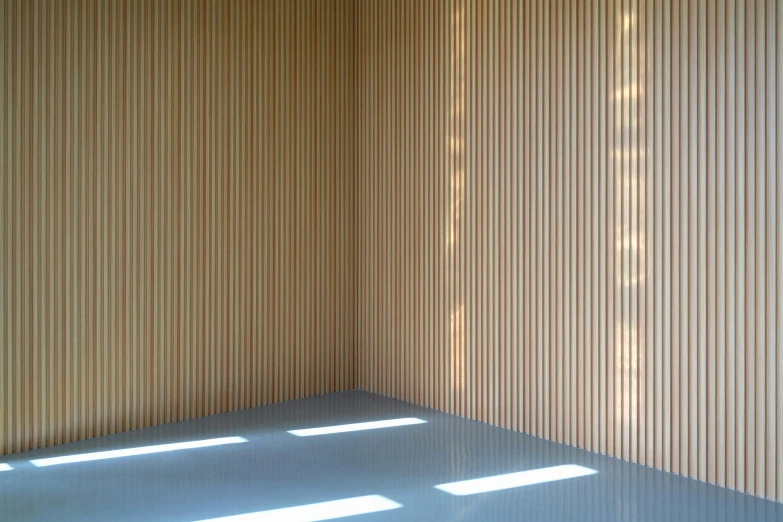 a corner of room with walls with wooden paneling