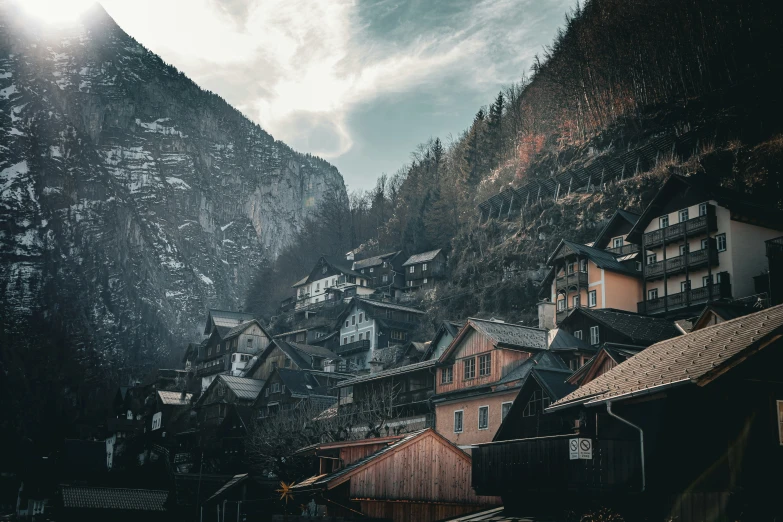 a mountain town with lots of trees on the hill