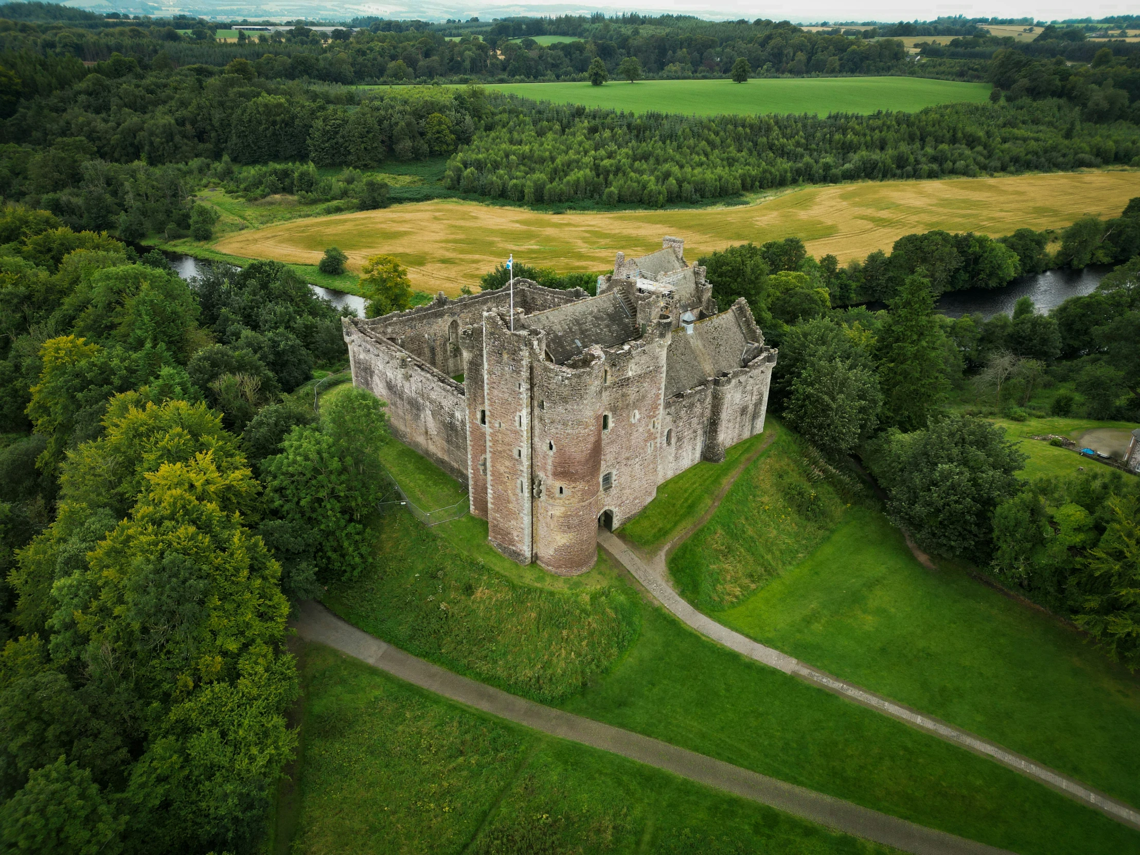 an aerial s of a castle surrounded by trees