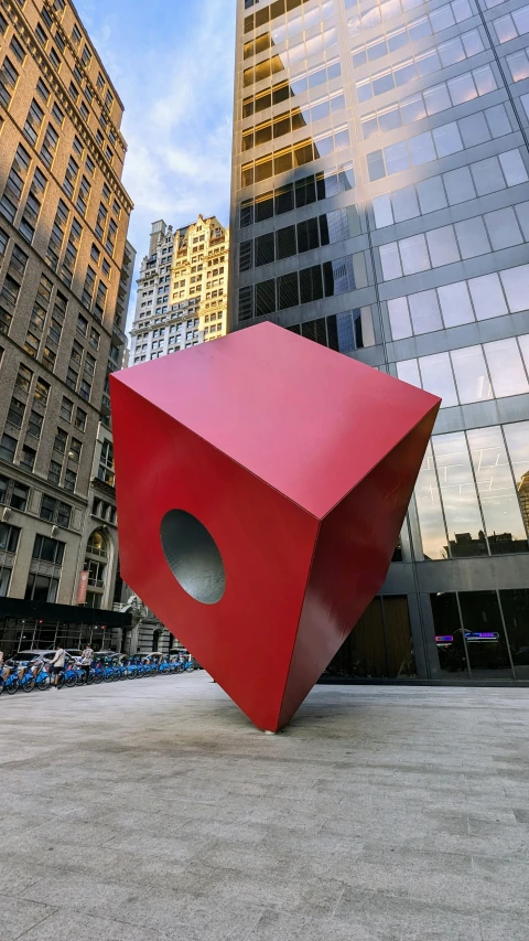 the big red object is near many tall buildings