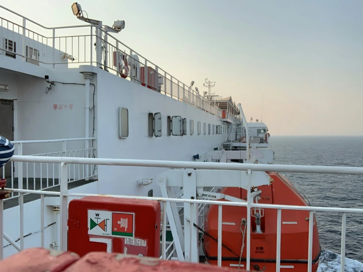 a man standing on the deck of a large ship