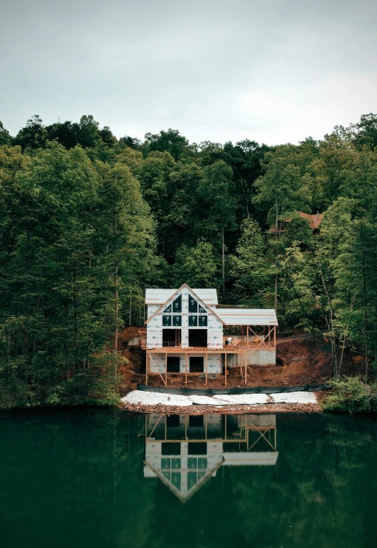 a small house by the water with its windows missing