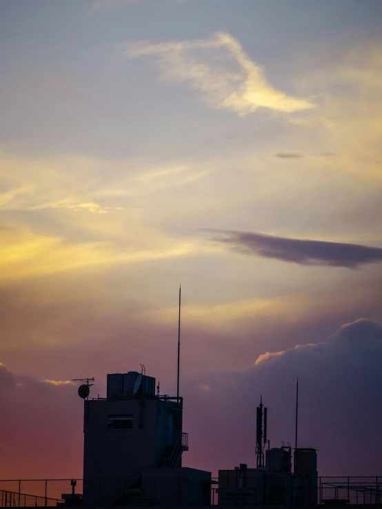 the jetliner is flying across the cloudy sky