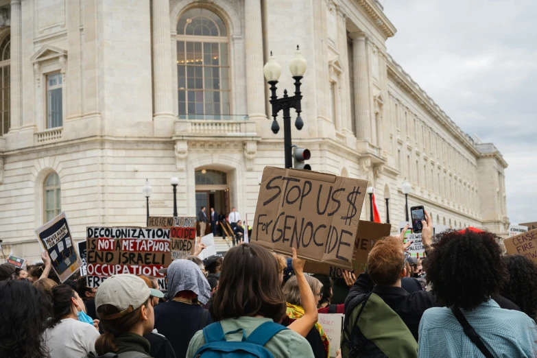 people in front of a building with signs and a street light