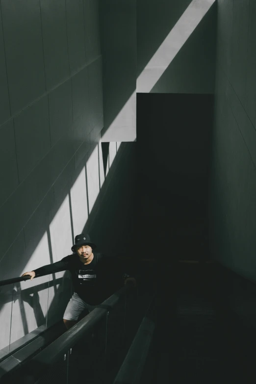 an image of woman on stairs in the shadows