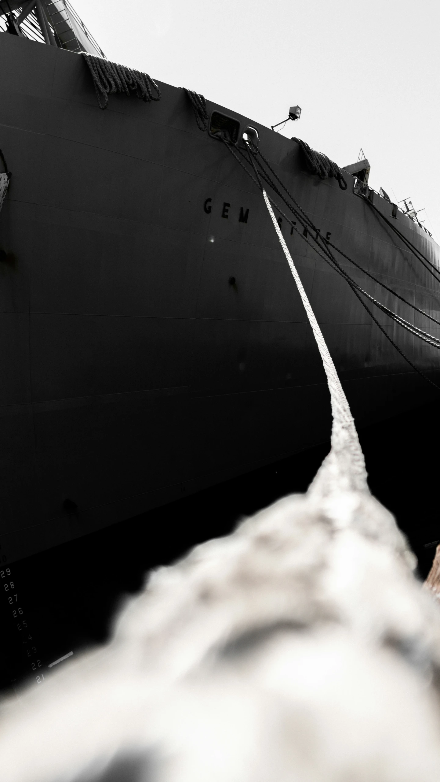 a large ship is anchored at the harbor