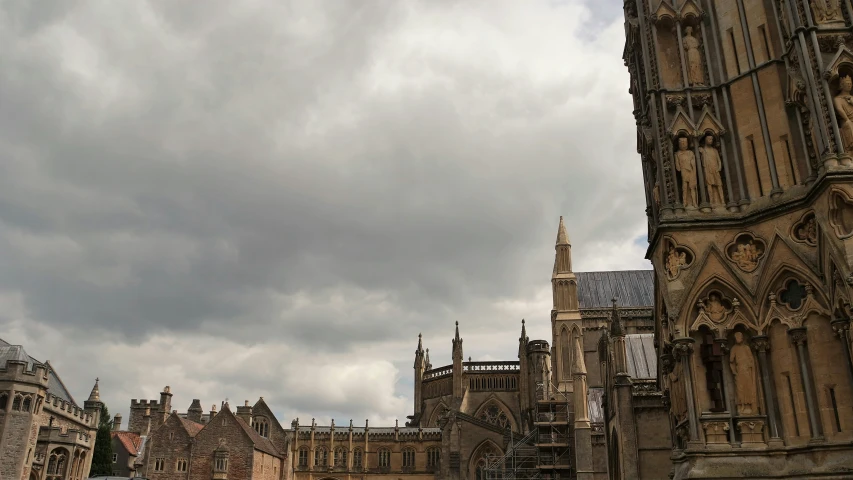 an old cathedral under cloudy skies with dark clouds